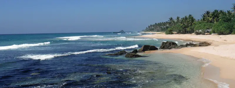 Waves breaking over the reef along the coast near Gurubebila, Sri Lanka